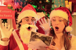 Heath dressed as Santa reading a shocking letter